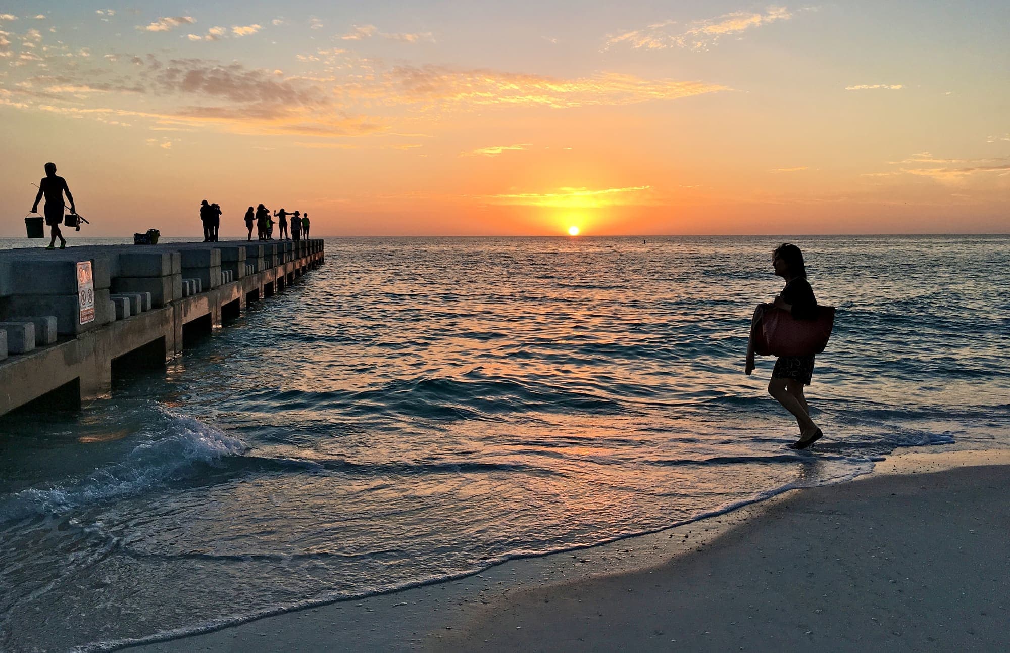 The sea wall groyne at Cortez Beach at sunset
